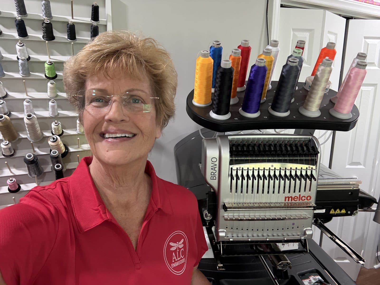 Linda Salter with the Melco Bravo embroidery machine and Madeira thread at ALC Embroidery